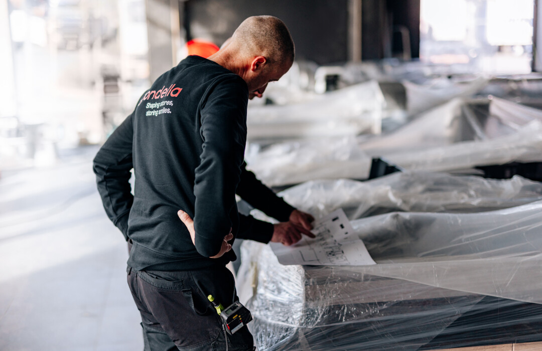 Gondella technician inspecting retail shelving installation on construction site