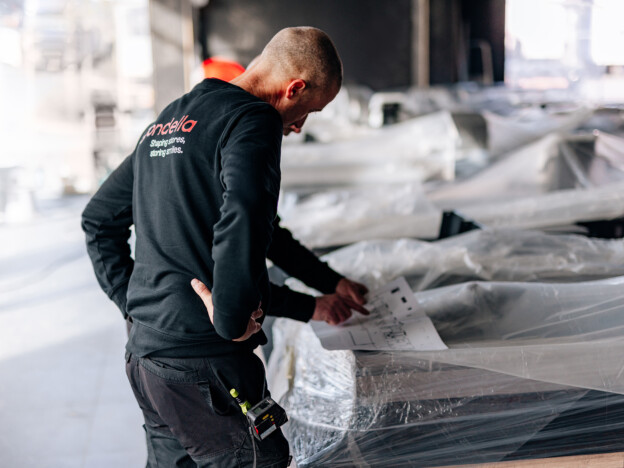 Gondella technician inspecting retail shelving installation on construction site