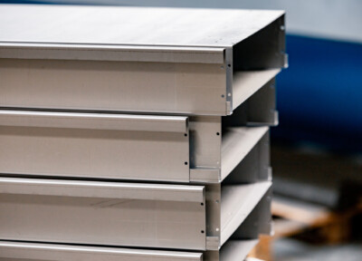 Stainless steel shelving unit with multiple tiers and bracket supports, typical of retail display solutions