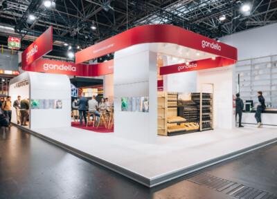 Gondella exhibition stand at Euroshop Düsseldorf 2023 featuring red branding, product displays, and retail shelving solutions