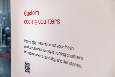 Custom cooling counter display with red text describing high-quality product presentation for supermarkets, specialty and deli stores