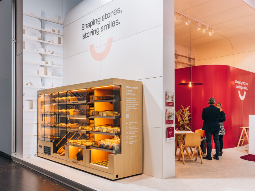 Gondola bakery display with illuminated shelving and warm wood finish, showcasing tailor-made bread furniture at Euroshop 2023