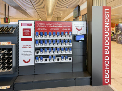 Digital product display kiosk with mobile devices showcasing technology recycling promotion in retail environment