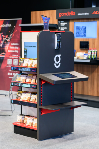 Gondella self-checkout kiosk with product display shelving at retail trade show