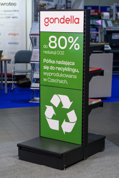 Gondella promotional display showcasing recycled materials, up to 80% CO2 reduction, with white recycling symbol on green background at retail trade show