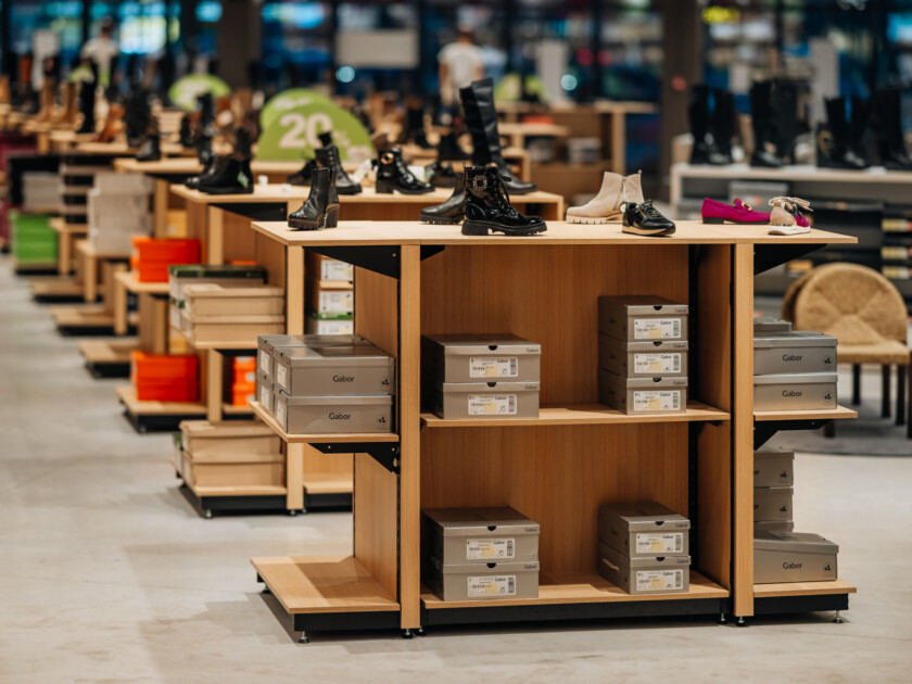 Gondella Pitch shelving displays with Gabor shoe boxes in retail showroom setting