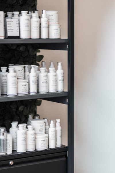 Keune Care hair products displayed on black Pitch 25 shelving in health & beauty retail setting
