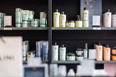 Health & beauty retail display with Pitch shelving showcasing multiple product lines in glass jars and bottles with branded packaging