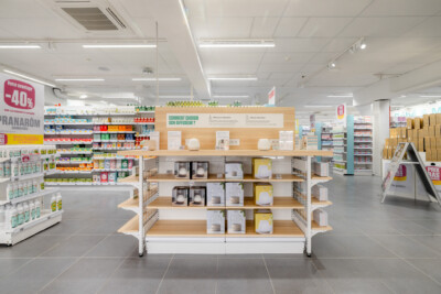 Medi-Market health and beauty retail display with Pitch shelving, diffuser products, and wooden gondola in store environment