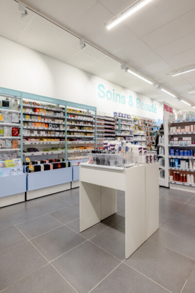 Health & beauty retail display with Pitch shelving, checkout counter and wall-mounted gondolas in Medi-Market store