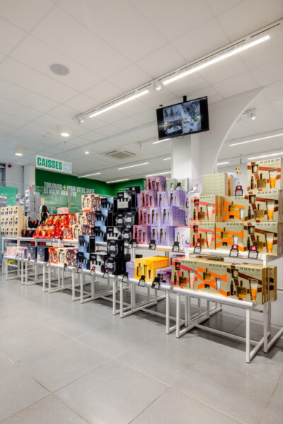 Medi-Market pharmacy retail display with Pitch shelving units featuring NUXE beauty products in orange, purple and natural wood finishes