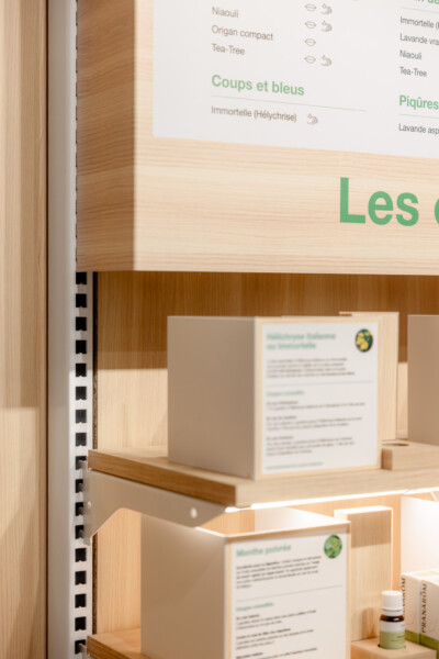 Gondella shelving display in Medi-Market pharmacy with product information cards and essential oils