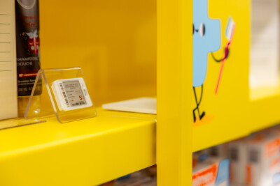Pitch 25 shelving with yellow fascia display and price ticket holder in health & beauty retail environment