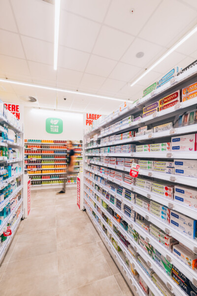 Health-beauty retail aisle with Pitch shelving displaying toothpaste, mouthwash and dental care products