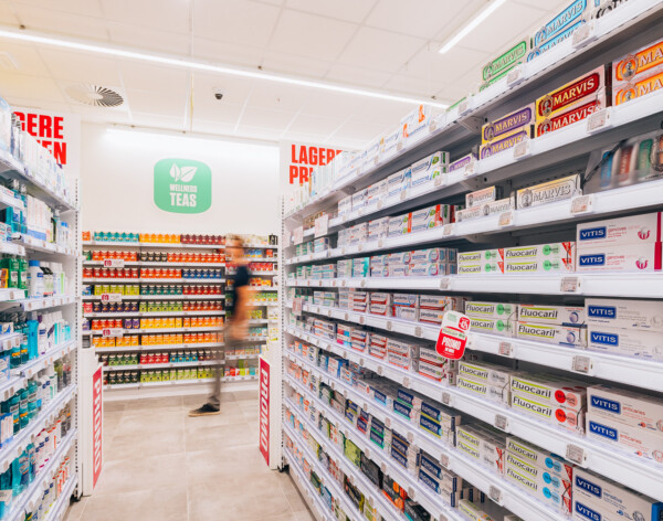 Health-beauty retail aisle with Pitch shelving displaying toothpaste, mouthwash and dental care products