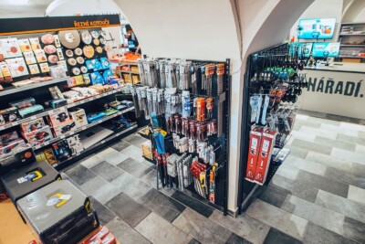 REWE supermarket tool display with Pitch shelving system showing hand tools, drill bits, and accessories on black pegboard units
