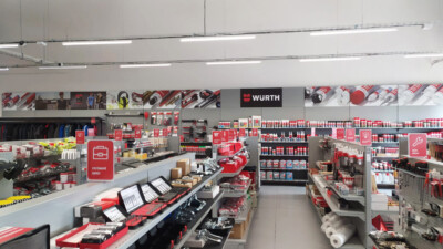 Würth retail store interior with red shelving displaying tools, hardware products, and supplies across multiple gondolas and wall-mounted displays