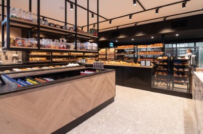 Modern bakery display with Gondella cooling counters and shelving showcasing bread, pastries and packaged goods in a bright retail environment