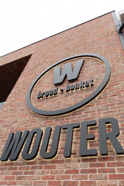 Wouter bread and pastries bakery storefront with metal signage on red brick building