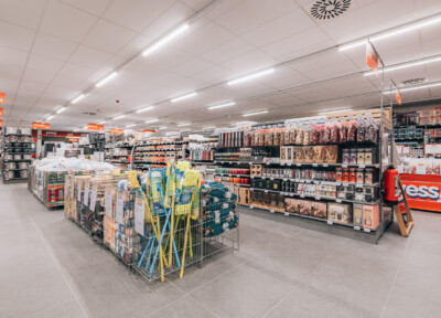 Yess supermarket interior with Pitch shelving displaying household products, beauty items, and packaged goods across multiple aisles
