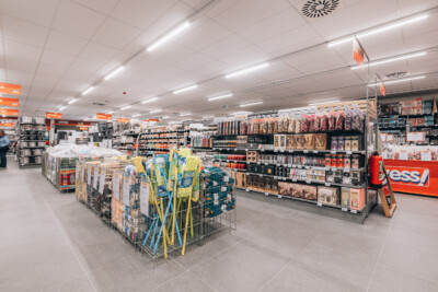 Yess supermarket interior with Pitch shelving displaying household products, beauty items, and packaged goods across multiple aisles