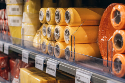 Yellow Pitch shelving display with product packaging and price labels in retail environment