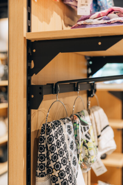 Pitch 25 shelving with black rail and hangers displaying patterned clothing in fashion retail
