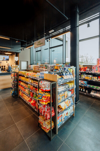 Candy and snack gondola display with Pitch shelving in convenience store setting