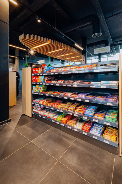 Pitch 25 refrigerated display case stocked with packaged snacks and confectionery in Louis Delhaize supermarket
