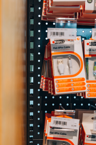 Pitch 25 shelving with perforated metal standards displaying packaged cables and electronic accessories