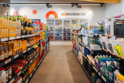 Q8 service station convenience store with Pitch 25 shelving displaying beverages, snacks and automotive products
