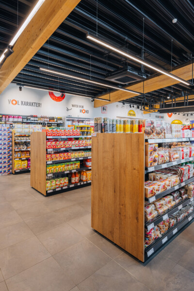 Q8 service station interior with wooden Pitch shelving displaying packaged food products and beverages