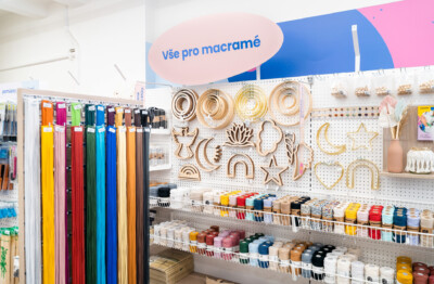 Macramé craft supplies display with wooden embellishments, colored cords, and twine organized on Pitch shelving with pegboard backing