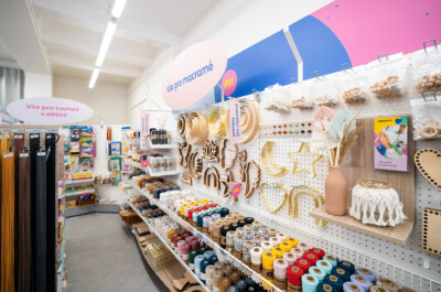 Craft supply retail display with Pitch shelving showcasing threads, wooden macramé rings, and decorative materials in health & beauty sector