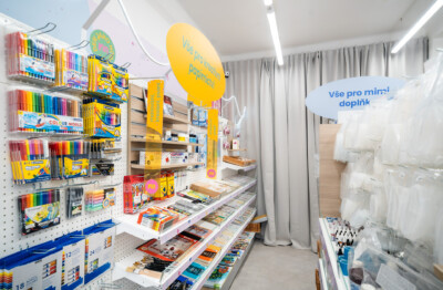 Specialty retail store with Pitch 25 shelving displaying colored pencils, markers and art supplies with yellow promotional signage