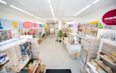Modern craft supply retail store with Pitch shelving displaying yarns, threads, paints, and DIY materials with light wood fixtures and colorful wall signage