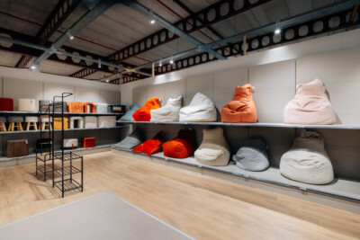 Pitch 25 shelving display with bean bags and soft furnishings in retail showroom setting