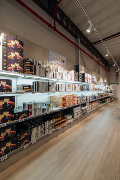Pitch 25 shelving with orange and black beverage displays in retail store