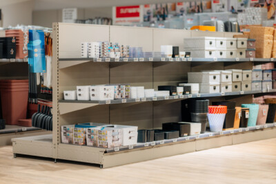 Pitch 25 shelving display with storage containers, boxes and retail products in beige and black finishes