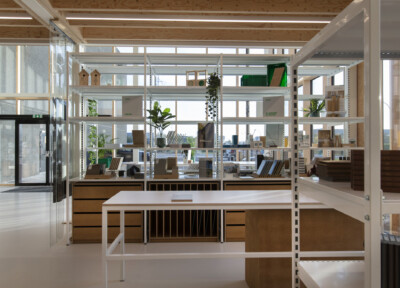 Pitch 41 shelving display with white metal framework, wooden base units, and integrated hanging plant displays in retail showroom setting