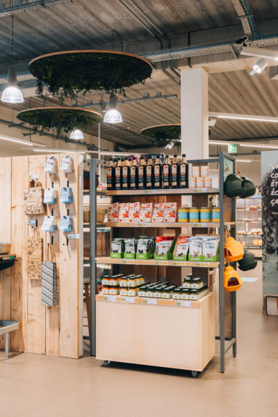 Bio-Planet specialty food retail display with Pitch 25 shelving, suspended green plant features, and packaged organic products
