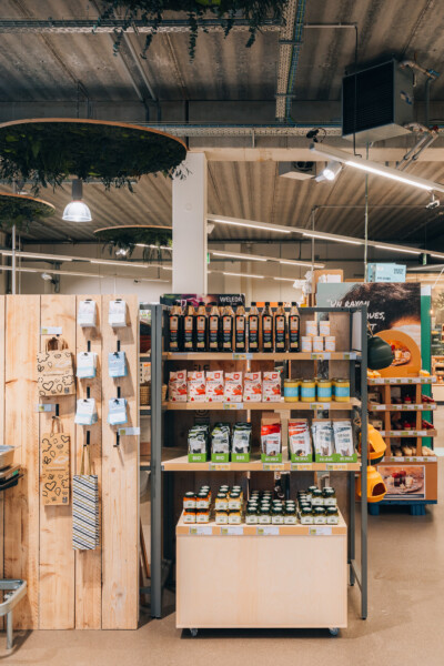 Weleda and organic product display on Pitch 41 shelving in supermarket setting with wooden fixtures