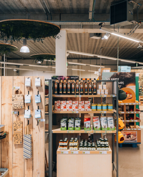 Weleda and organic product display on Pitch 41 shelving in supermarket setting with wooden fixtures