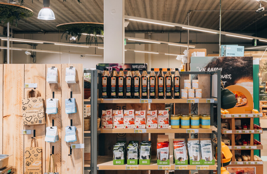 Weleda and organic product display on Pitch 41 shelving in supermarket setting with wooden fixtures
