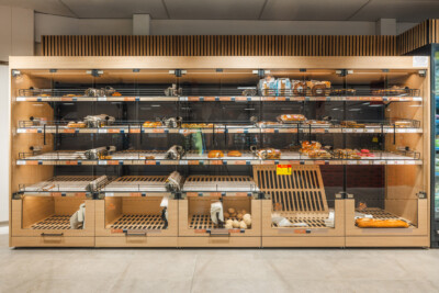 Carrefour Market Sint-Jozef Brugge bakery section with Pitch shelving displaying bread, pastries and fresh goods