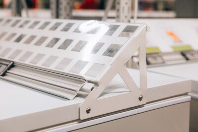 Pitch 25 shelving with sample material swatches displayed on adjustable bracket in retail setting