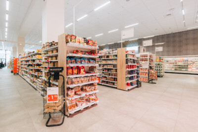 Delhaize supermarket snack aisle with Pitch 25 shelving displaying packaged food products
