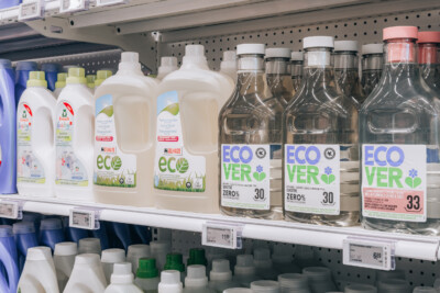 Delhaize supermarket detergent shelf display with Ecover and Frosch eco-friendly cleaning products in various sizes