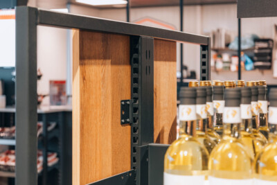 Pitch 41 shelving with wooden panels and black metal frame displaying white-labeled wine bottles in retail environment