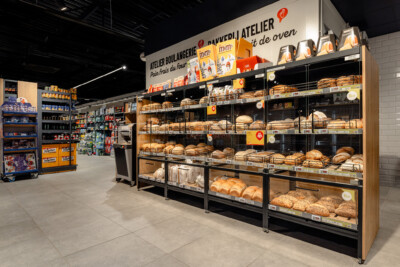 Bakery atelier shelving display with breads and pastries in climate-controlled cases, Delhaize supermarket